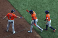 Houston Astros' Jake Meyers (6) celebrates with Yordan Alvarez (44) and Jose Altuve (27) after Alvarez' three-run home run in the third inning of a baseball game against the Texas Rangers Sunday, April 7, 2024, in Arlington, Texas. (AP Photo/ Richard W. Rodriguez)