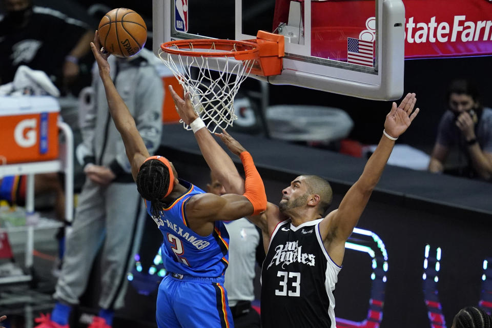 Oklahoma City Thunder guard Shai Gilgeous-Alexander (2) shoots as Los Angeles Clippers forward Nicolas Batum (33) defends during the first quarter of an NBA basketball game Friday, Jan. 22, 2021, in Los Angeles. (AP Photo/Ashley Landis)