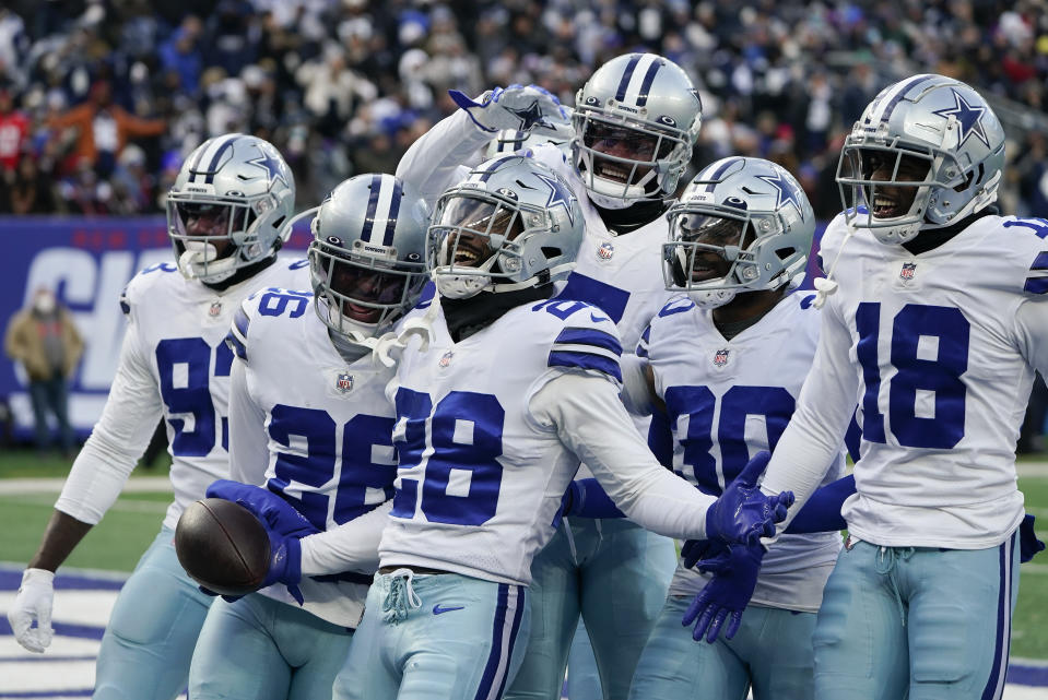 Dallas Cowboys safety Malik Hooker (28) celebrates with teammates after intercepting a pass against the New York Giants during the fourth quarter of an NFL football game, Sunday, Dec. 19, 2021, in East Rutherford, N.J. (AP Photo/Seth Wenig)