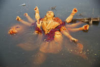 <p>An idol of the Hindu goddess Durga floats in a temporary pond near the River Ganges after its immersion in Allahabad, India, Saturday, Sept. 30, 2017. The immersion of idols marks the end of the festival that commemorates the slaying of a demon king by lion-riding, 10-armed goddess Durga, marking the triumph of good over evil. (Photo: Rajesh Kumar Singh/AP) </p>