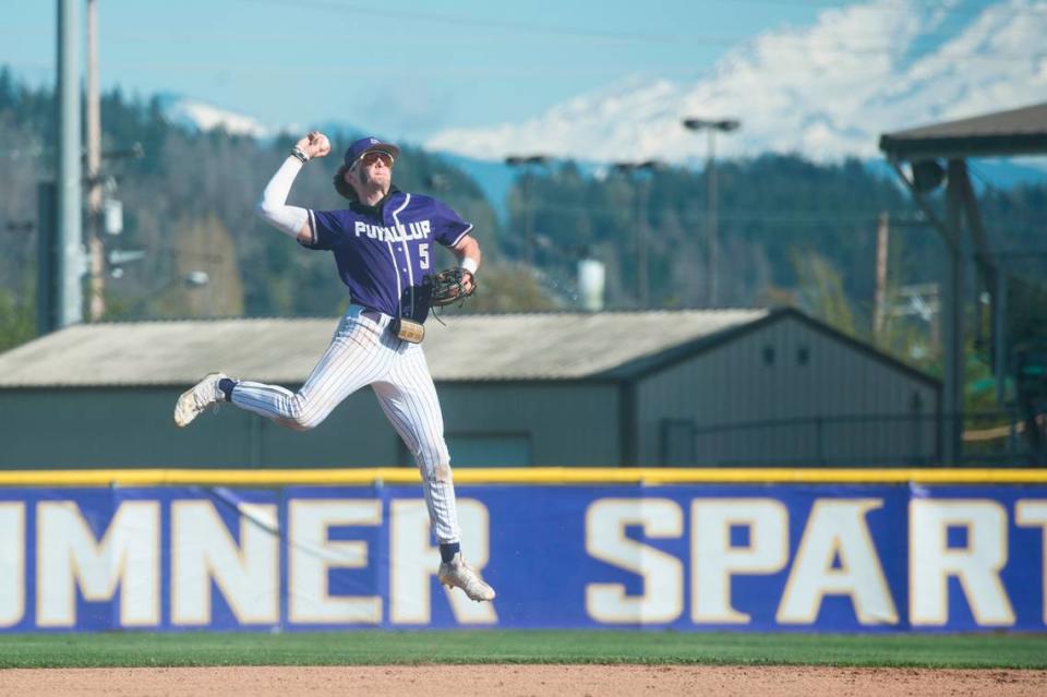 Puyallup shortstop Gage Thompson makes a leaping throw to first base after fielding a ground ball in a Class 4A South Puget Sound League baseball game against Sumner on Tuesday, April 25, 2023 at Sumner High School in Sumner, Wash.