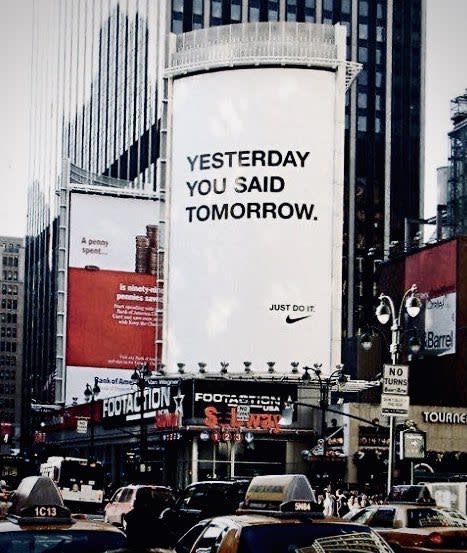 A large white Nike billboard featuring the phrase 