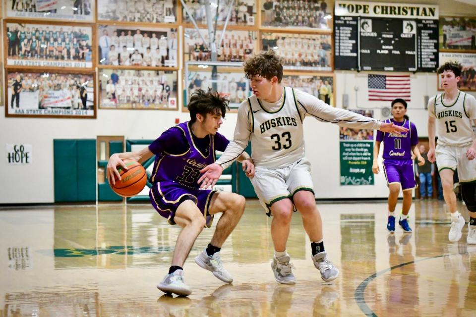 Kirtland Central's Brandon Ockerman (33) keeps control of the dribble and looks for a path into the lane while being guarded by Hope Christian's Xavier Otero during an opening round game of the Class 4A state basketball tournament, Saturday, March 4, 2023 at Hope Christian.