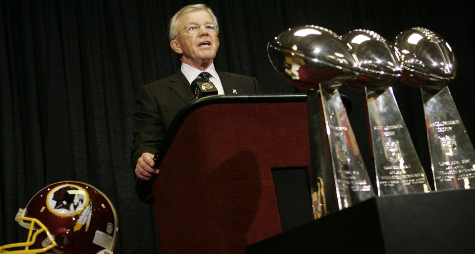 Joe Gibbs with three Super Bowl trophies. 