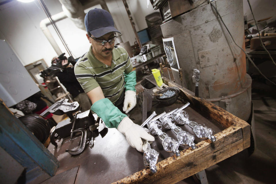 CHICAGO, IL - FEBRUARY 09: Martin Vega sets an Oscar statuette down to cool off after it was cast at R.S. Owens & Company February 9, 2012 in Chicago, Illinois. R.S. Owens manufactures the Oscar statuettes which are presented at the annual Academy Awards by the Academy of Motion Picture Arts and Sciences. After the theft of the statuettes prior to the 2000 Academy Awards the company began casting the statuettes one year in advance of the show. (Photo by Scott Olson/Getty Images)