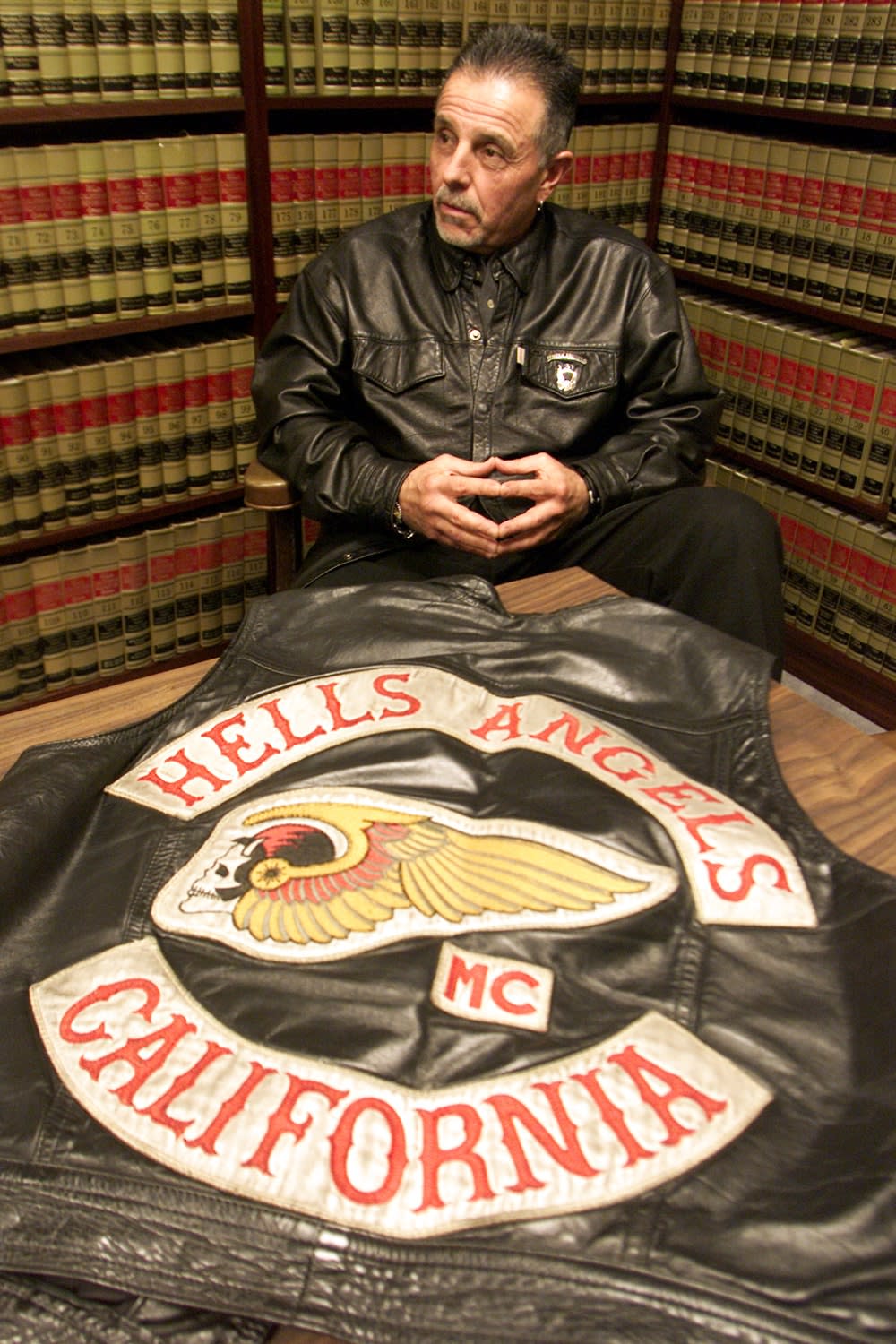George Christie sitting in front of a Hells Angels patch