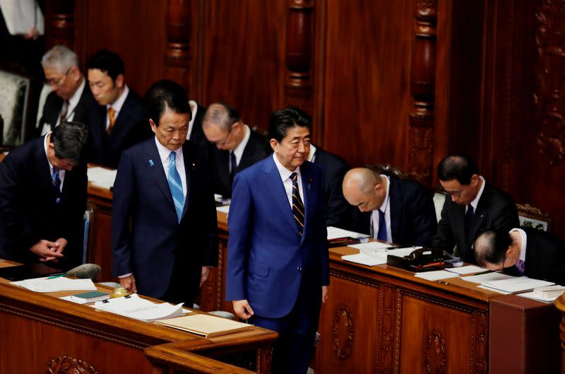 Japanese Prime Minister Shinzo Abe and Finance Minister Taro Aso attend the regular session of parliament in Tokyo