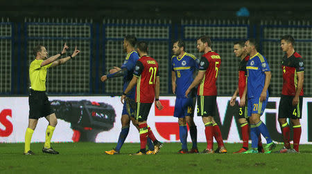 Referee Willie Collum gestures as Bosnia and Belgium players approach him REUTERS/Dado Ruvic