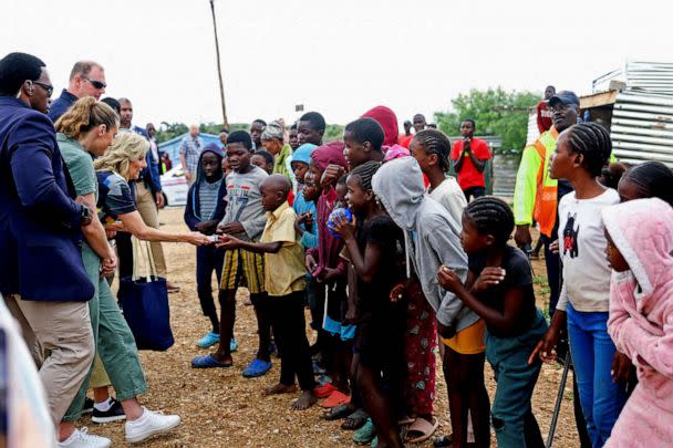 PHOTO: U.S. first lady Jill Biden handouts sweets to children outside the Hope Initiatives Southern Africa, in Windhoek, Namibia, Feb. 23, 2023. (Siphiwe Sibeko/Reuters)