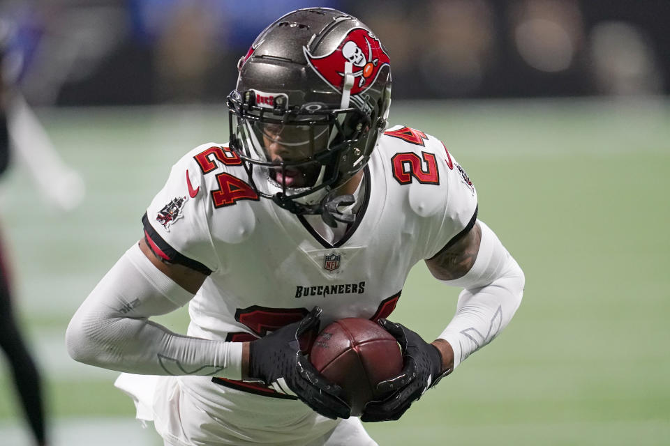 FILE - Tampa Bay Buccaneers cornerback Carlton Davis III runs with the ball after intercepting a pass during the first half of an NFL football game against the Tampa Bay Buccaneers, Sunday, Dec. 10, 2023, in Atlanta. Detroit acquired cornerback Davis from Tampa Bay for pick No. 92 in the NFL draft and agreed to a $20 million, three-year contract that has $9.5 million in guarantees with guard Graham Glasgow, a person familiar with the situation said Monday, March 11, 2024. (AP Photo/Mike Stewart, File)