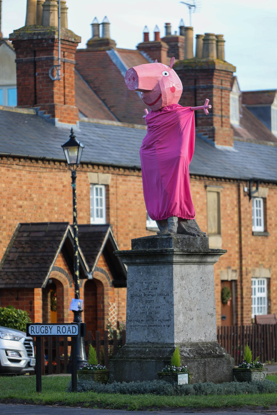 A village is hunting festive pranksters who have turned a statue of its most famous son into PEPPA PIG. The statue of Lord John Scott, who died in 1860, is a Christmas target for jokers in Dunchurch, near Rugby, Warks. Hilarious pictures show the monument draped in a pink sheet with arms stretched out and a huge pink papier mache head resembling kids' TV favourite. The statue has previously been turned into Harry Potter, Shrek, Happy Feet, Pikachu, Homer Simpson, an Olympic athlete and The Grinch in an annual tradition dating back to the 1970s.