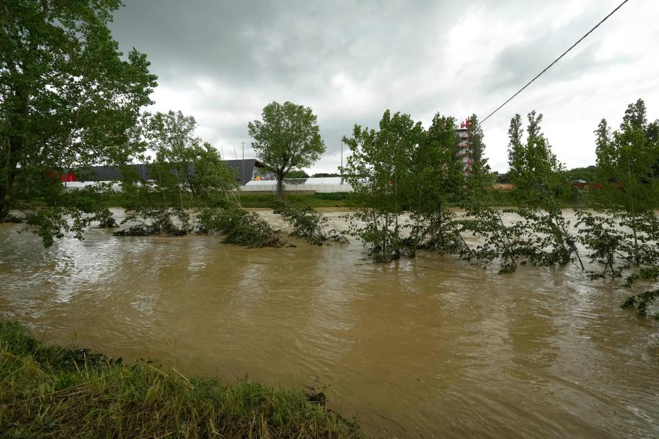 A view of the swollen Santerno River with behind the Enzo e Dino Ferrari circuit, in Imola, Italy, Wednesday, May 17, 2023. The weekend's Emilia-Romagna Grand Prix in Imola has been canceled because of deadly floods. Formula One said it made the decision for safety reasons and to avoid any extra burden on the emergency services. F1 personnel had earlier been told to stay away from the track after floods affected large parts of the Emilia-Romagna region.