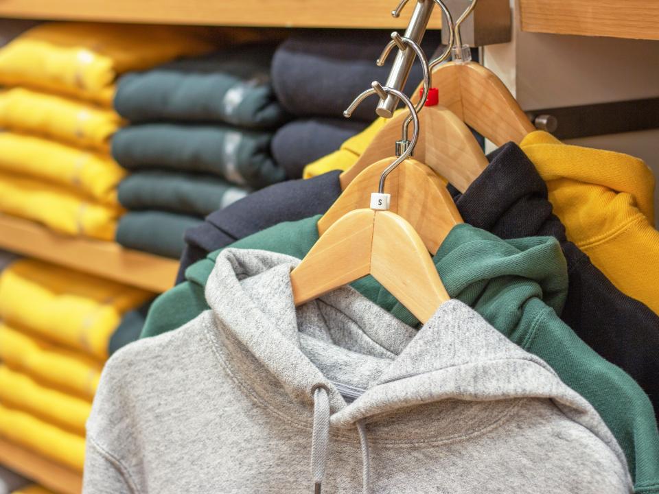 hoodie hooded sweatshirts on a rack in a store