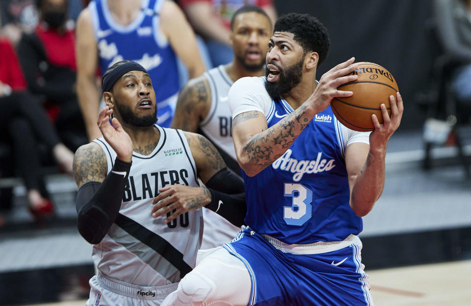 Los Angeles Lakers forward Anthony Davis, right, shoots over Portland Trail Blazers forward Carmelo Anthony during the first half of an NBA basketball game in Portland, Ore., Friday, May 7, 2021. (AP Photo/Craig Mitchelldyer)