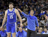 Duke head coach Jon Scheyer directs his team during the second half of an NCAA college basketball game against Boston College, Saturday, Jan. 7, 2023, in Boston. At left is Duke player Ryan Young (15). (AP Photo/Mark Stockwell)