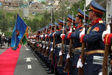 Afghan President Ashraf Ghani inspects an honor guard during the first day of the Loya Jirga, or the consultative council, in Kabul, Afghanistan, April 29, 2019. Rahmat Gul/Pool via REUTERS