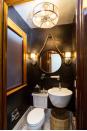 <p>In a small powder room, a floating shelf will be a life-saver for essentials like washcloths, hand soap, candles, and tissues. Interior designer <a href="https://www.gaildavisdesignsllc.com/" rel="nofollow noopener" target="_blank" data-ylk="slk:Gail Davis;elm:context_link;itc:0;sec:content-canvas" class="link ">Gail Davis</a> installed a simple glass shelf right under the mirror for a nice symmetrical display. </p>