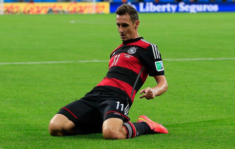Germany's forward Miroslav Klose celebrates after scoring during the semi-final football match between Brazil and Germany at The Mineirao Stadium in Belo Horizonte during the 2014 FIFA World Cup on July 8, 2014