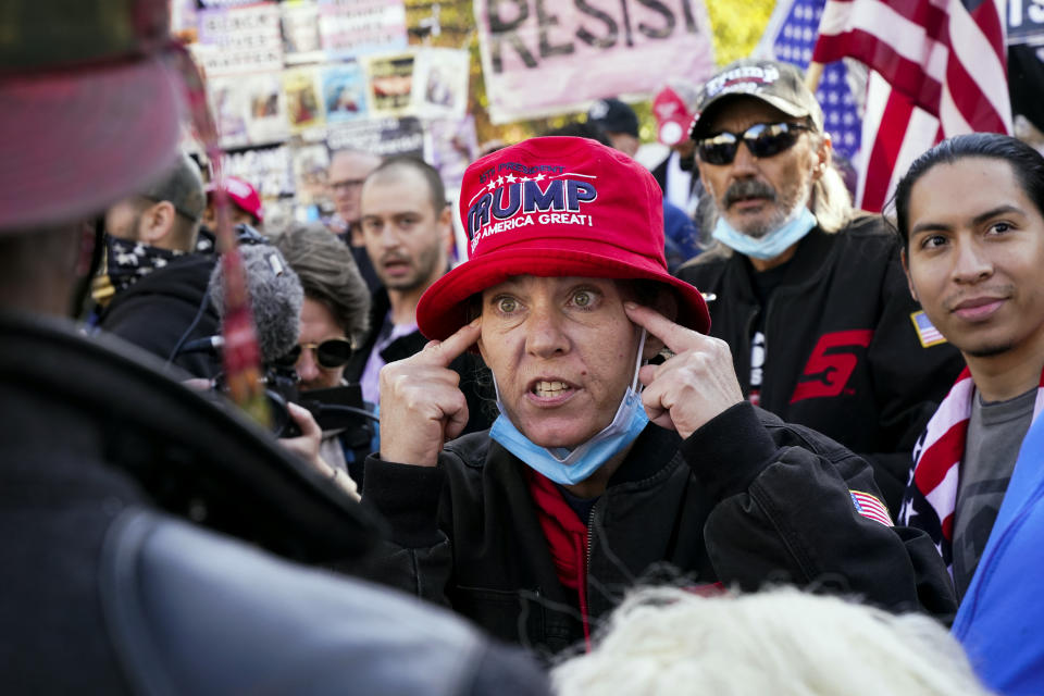 Supporters of President Donald Trump talk with counter-protestors during a rally Friday Nov. 13, 2020, in Washington. (AP Photo/Jacquelyn Martin)