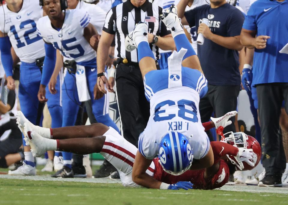 Brigham Young Cougars tight end Isaac Rex (83) runs over Arkansas Razorbacks defensive back Alfahiym Walcott (13) after catch at Razorback Stadium in Fayetteville on Saturday, Sept. 16, 2023. | Jeffrey D. Allred, Deseret News