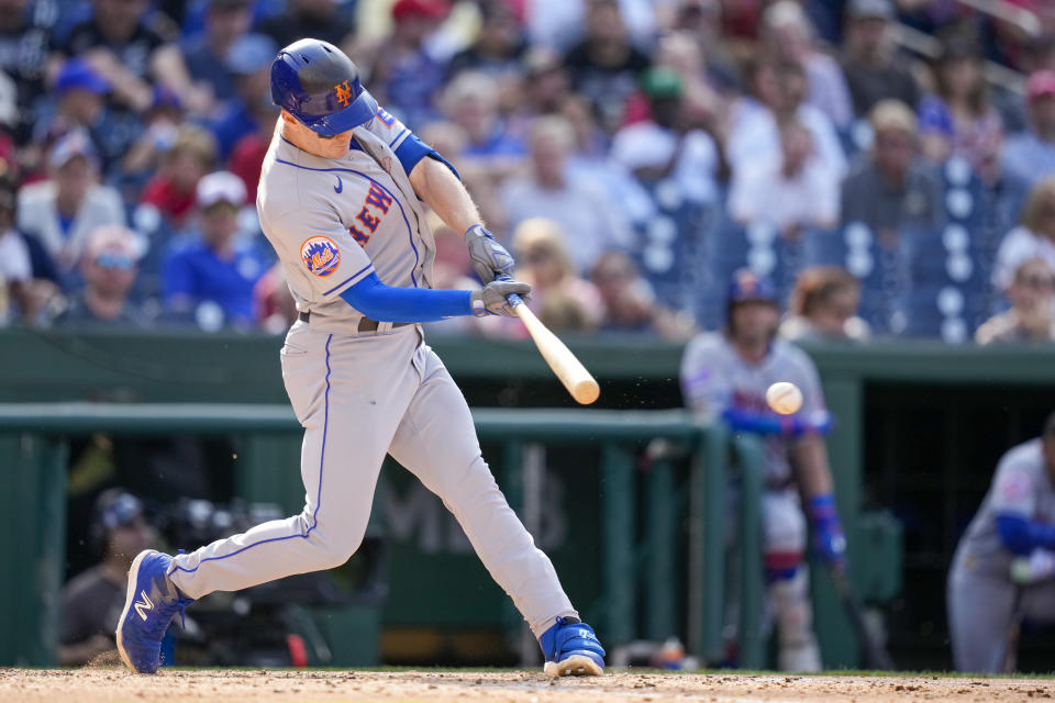 New York Mets' Mark Canha hits an RBI single during the fourth inning of a baseball game against the Washington Nationals at Nationals Park, Monday, May 15, 2023, in Washington. (AP Photo/Alex Brandon)