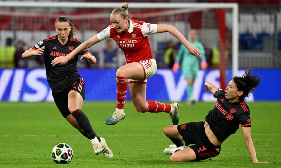 Arsenal’s Frida Maanum holds off Klara Bühl and Saki Kumagai in Munich.