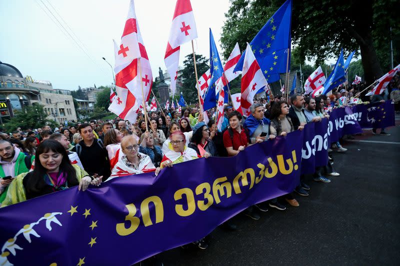 Demonstrators hold a rally to protest against a bill on "foreign agents" in Tbilisi