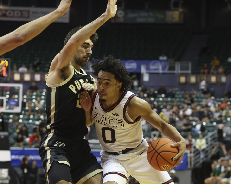 Gonzaga guard Ryan Nembhard (0) tries to get past Purdue guard Ethan Morton, left, during the first half of an NCAA college basketball game, Monday, Nov. 20, 2023, in Honolulu. (AP Photo/Marco Garcia)