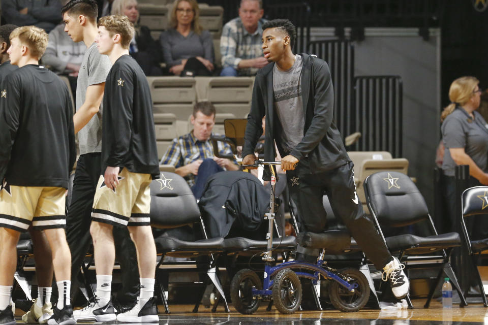 Injured Vanderbilt sophomore guard Aaron Nesmith uses a scooter and a walking boot as he watches his teammates play Texas A&M in an NCAA college basketball game Saturday, Jan. 11, 2020, in Nashville, Tenn. Nesmith is the SEC's leading scorer and fifth nationally averaging 23 points a game. Texas A&M won 69-50. (AP Photo/Mark Humphrey)