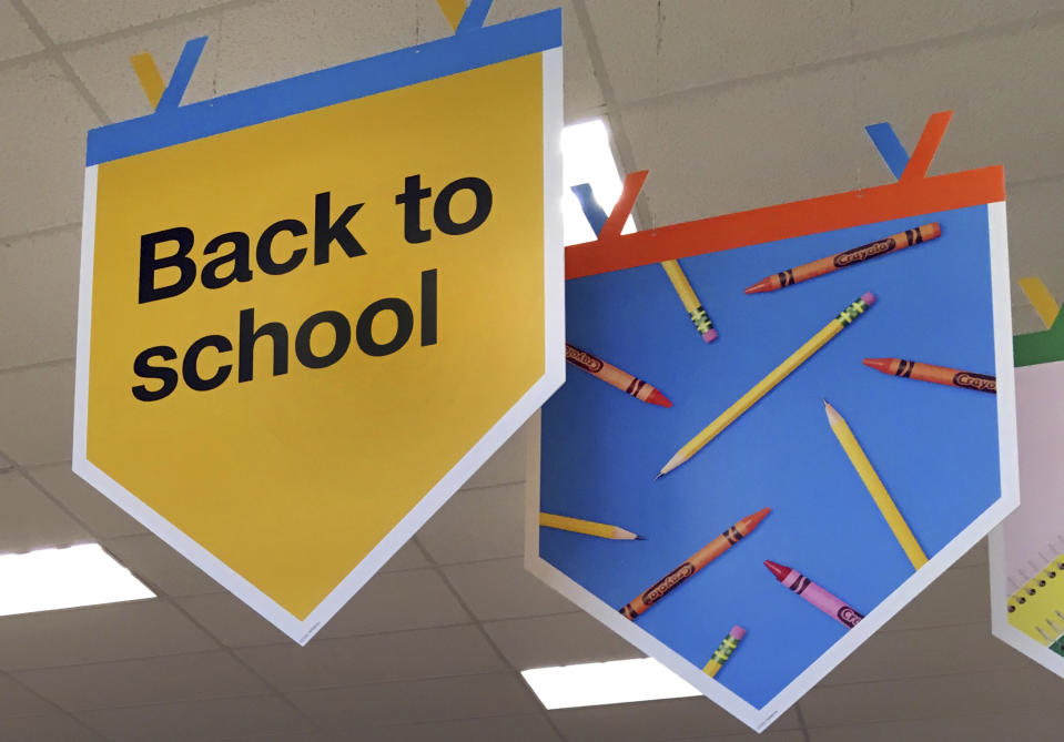 FILE - In this July 31, 2018 photo, "back to school" signage hangs in a store in Methuen, Mass. It might seem like you’ve been saving for back to school since you packed your children’s backpacks last fall. But after replacing worn-out erasers, outgrown clothes and an outdated laptop, you may still feel the financial pinch. (AP Photo/Elise Amendola, File)