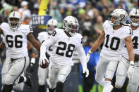 Las Vegas Raiders running back Josh Jacobs (28) celebrates after scoring a touchdown during the first half of an NFL football game against the Seattle Seahawks Sunday, Nov. 27, 2022, in Seattle. (AP Photo/Caean Couto)