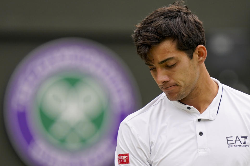 Chile's Cristian Garin is dejected during a men's singles quarterfinal match against Australia's Nick Kyrgios on day ten of the Wimbledon tennis championships in London, Wednesday, July 6, 2022. (AP Photo/Alberto Pezzali)