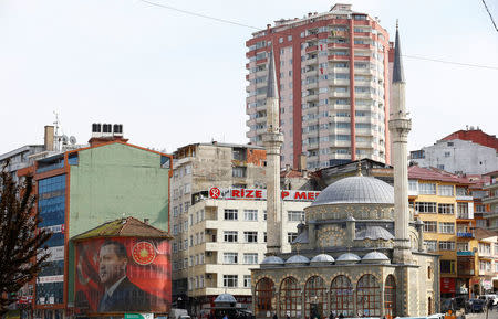 A huge portrait of Turkish President Tayyip Erdogan surrounds a building in Rize on the Black Sea coast, Turkey, April 3, 2017. Picture taken April 3, 2017. REUTERS/Umit Bektas