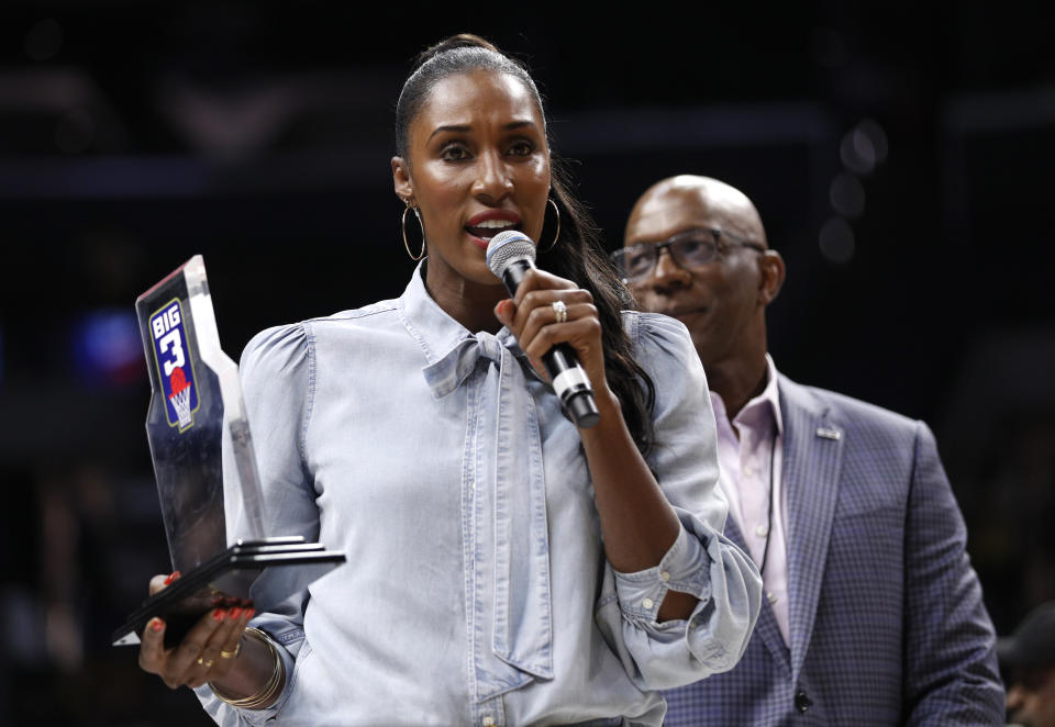 LOS ANGELES, CALIFORNIA - SEPTEMBER 01: Head coach Lisa Leslie of the Triplets is awarded the Coach of the Year trophy by BIG3 commissioner Clyde Drexler (R) during the BIG3 Championship at Staples Center on September 01, 2019 in Los Angeles, California. (Photo by Meg Oliphant/BIG3 via Getty Images)