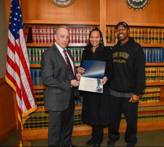 FBI Cleveland Special Agent in Charge Greg Nelsen presents Tamia and Timothy Woods with the Directors Community Leadership Award Feb. 20.