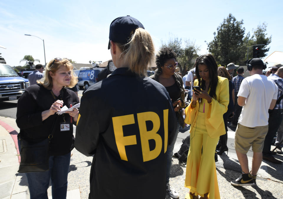 An FBI agent gives out information to members of the media outside of the Chabad of Poway Synagogue on Saturday. Source: AAP