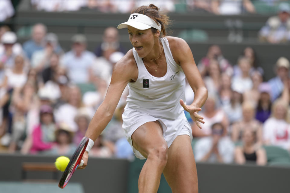 Germany's Tatjana Maria returns a ball to Germany's Jule Niemeier in a women's singles quarterfinal match at the Wimbledon tennis championships in London, Tuesday July 5, 2022. (AP Photo/Kirsty Wigglesworth)