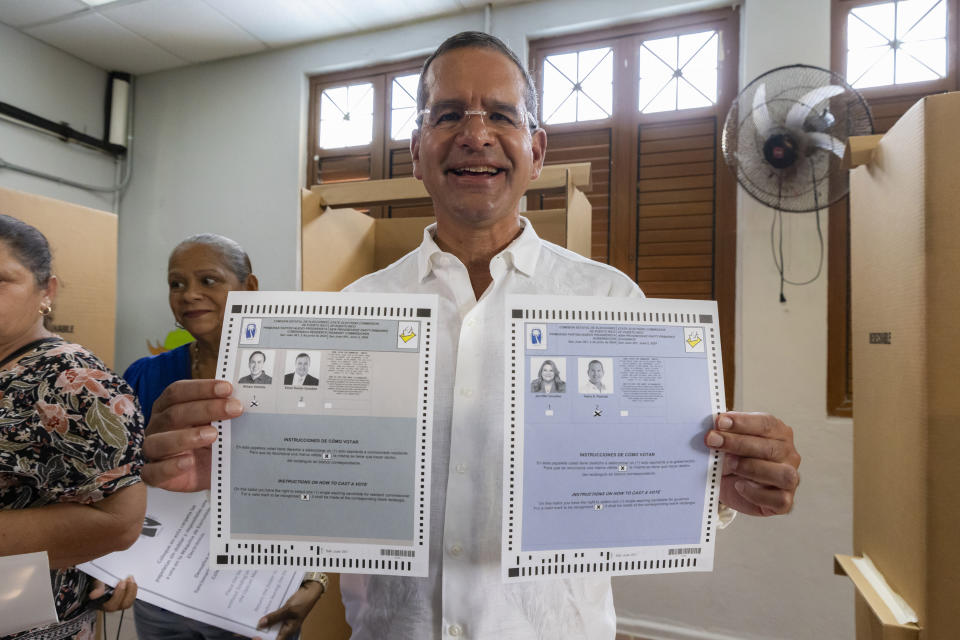 Gov. Pedro Pierluisi holds up his ballots during the gubernatorial primaries, in San Juan, Puerto Rico, Sunday, June 2, 2024. Pierluisi, head of the pro-statehood New Progressive Party, is seeking a second term. (AP Photo/Alejandro Granadillo)