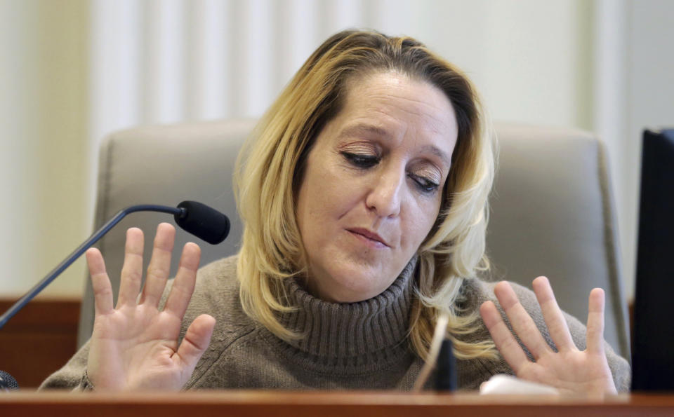 Lisa Britt throws up her hands as she answers a question by by attorney Marc Elias during the public evidentiary hearing on the 9th Congressional District investigation at the North Carolina State Bar Monday, Feb. 18, 2019, in Raleigh, N.C. (Juli Leonard/The News & Observer via AP, Pool)