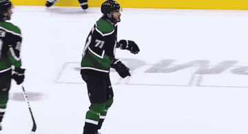 hockey player takes gloves off, ready for a fight