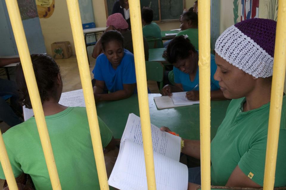 Prisoners study inside the renovated wing of the Najayo women's prison in San Cristobal, May 12, 2014. Ten years after the country opened its first prison designed with a focus on education and clean living conditions and staffed by graduates from a newly created academy for penitentiary studies, the New Model of Prison Management is gaining recognition from other countries in the region trying to reduce prison populations and cut recidivism rates. Picture taken May 12, 2014. REUTERS/Ricardo Rojas (DOMINICAN REPUBLIC - Tags: CRIME LAW POLITICS SOCIETY)