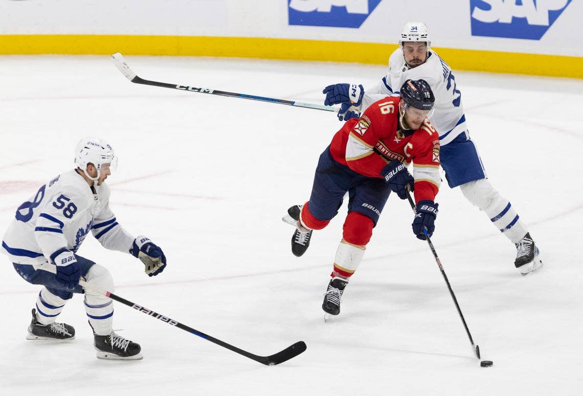 Florida Panthers center Aleksander Barkov (16) tries to keep the puck from Toronto Maple Leafs center Auston Matthews (34) and left wing Michael Bunting (58) during the third period of Game 3 of the Eastern Conference second-round NHL Stanley Cup series on Sunday, May 7, 2023, at FLA Live Arena. The score was tied 2-2 at the end of the third period.