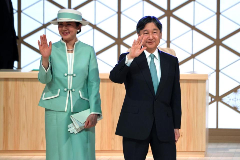 Emperor Naruhito and empress Masako wave to participants after attending the National Tree Planting Festival at ZIP Arena Okayama on May 26 (The Asahi Shimbun via Getty Images)