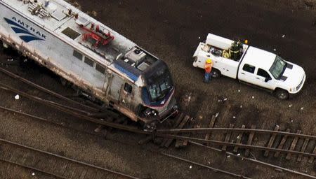 Emergency workers look through the remains of a derailed Amtrak train in Philadelphia, Pennsylvania in this May 13, 2015 file photo. REUTERS/Lucas Jackson/Files