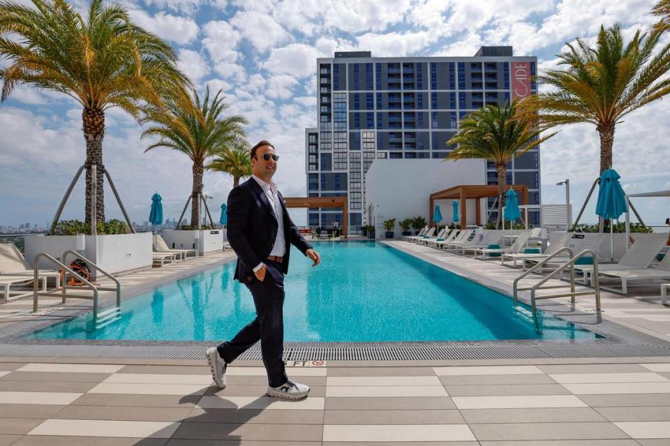 Developer Arnaud Karsenti, managing principal at developer 13th Floor Investments, walks by the pool on the amenity deck of the CORE Link apartment building at the Douglas Road Metrorail Station. Visible at rear is the newly opened companion Csascade apartment tower.