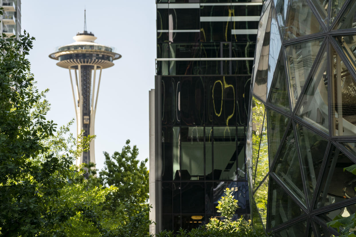 SEATTLE, WA - MAY 20: The Space Needle is seen near The Spheres at the Amazon.com Inc. headquarters on May 20, 2021 in Seattle, Washington. Five women employees sued Amazon this week, alleging discrimination and retaliation. (Photo by David Ryder/Getty Images)