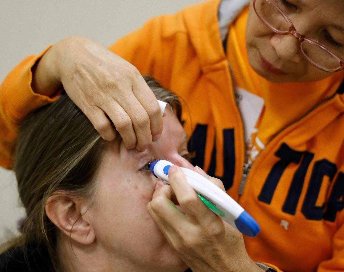 Nurse Anhhong Le performs a pressure test for glaucoma on Sherri Hellige at the Remote Area Medical Clinic at the Southwestern Baptist Theological Seminary in Fort Worth on Saturday. The clinic is available to anyone who wished to use its services.