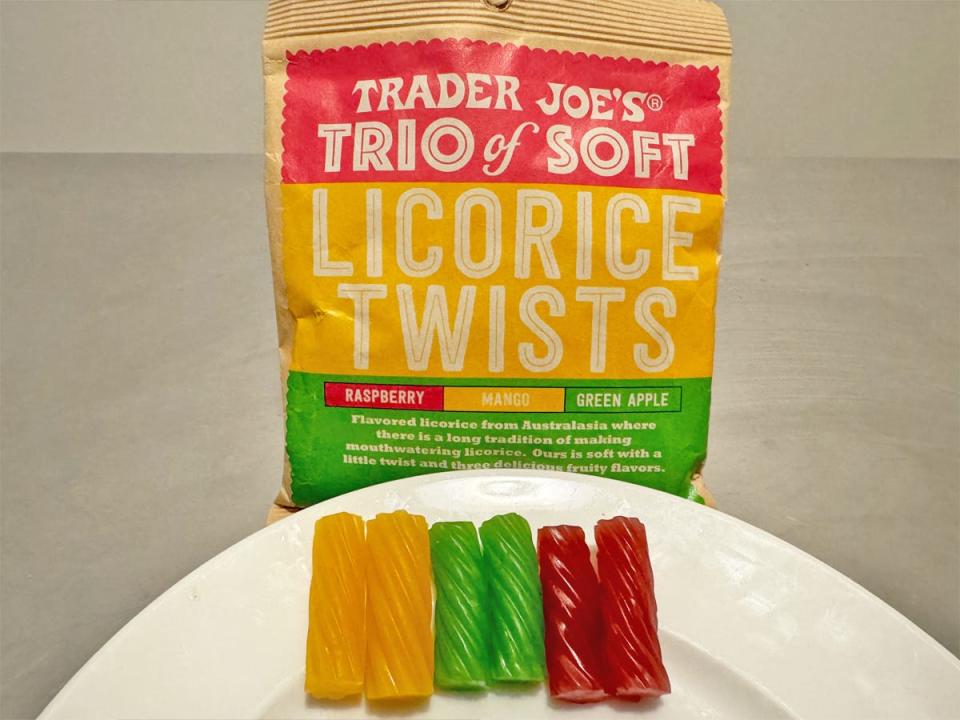 A bag with red, yellow, and green with licorice in front