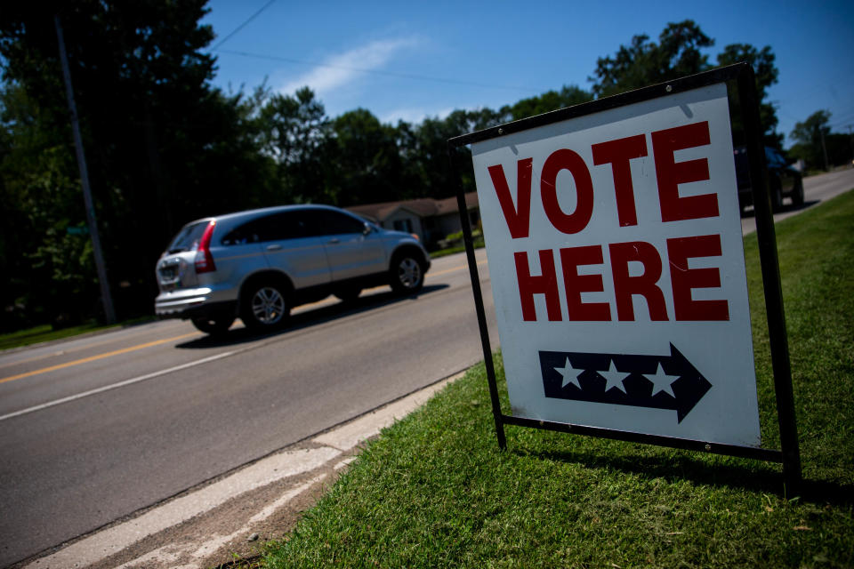 Cars pass a polling location in Holland Charter Township on Tuesday, Aug. 2, 2022.