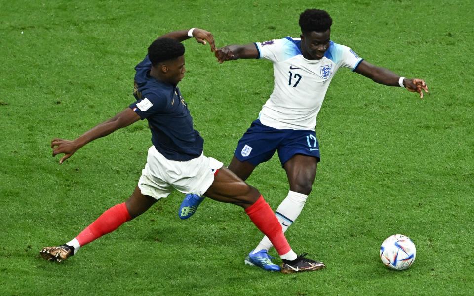 France's midfielder #08 Aurelien Tchouameni fouls England's forward #17 Bukayo Saka - AFP